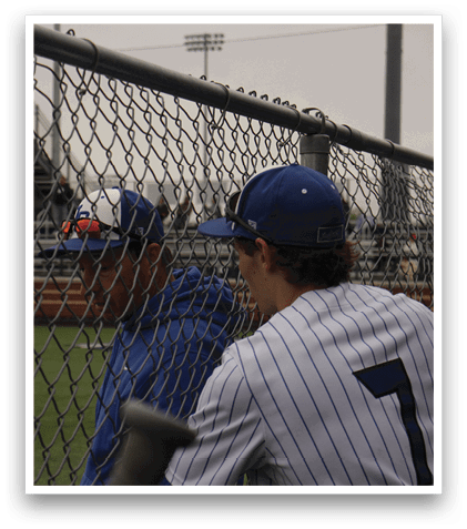 Two baseball players wearing blue and white uniforms. Description generated by AI