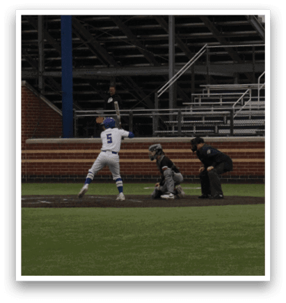 A baseball player is swinging a bat on a field. Description generated by AI