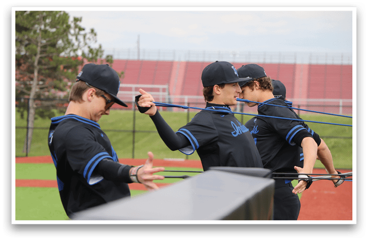 A baseball player wearing a black shirt and blue hat. Description generated by AI