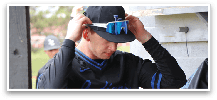 A man wearing a black and blue baseball jersey with the number 4 on it. Description generated by AI