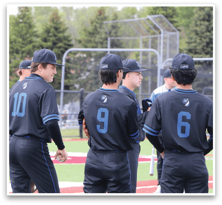 A group of baseball players wearing black and blue uniforms. Description generated by AI