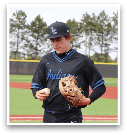 A baseball player wearing a black shirt and holding a brown glove. Description generated by AI