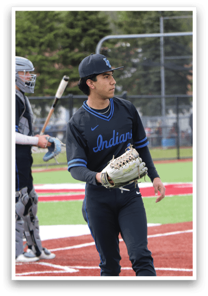 A baseball player wearing a black shirt and blue hat. Description generated by AI