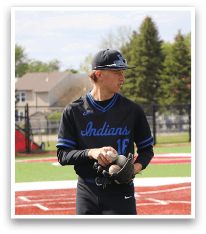 A baseball player wearing a black jersey with the number 14 on it. Description generated by AI