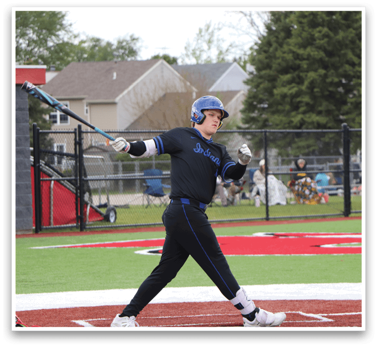 A baseball player in a black shirt and blue helmet is swinging a bat. Description generated by AI