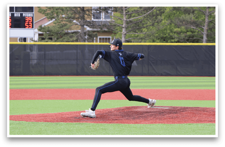 A baseball pitcher in a blue shirt and black pants is throwing a pitch. Description generated by AI