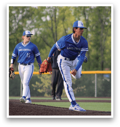 Two baseball players wearing blue uniforms and white shoes. Description generated by AI