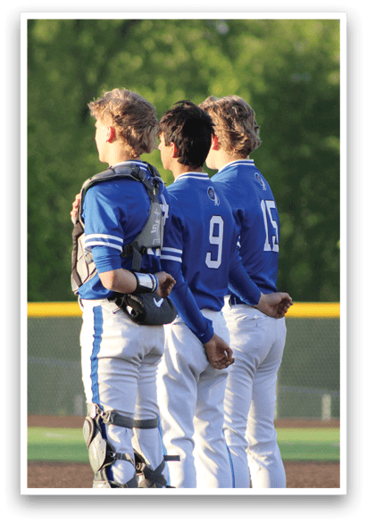Three baseball players wearing blue and white uniforms. Description generated by AI