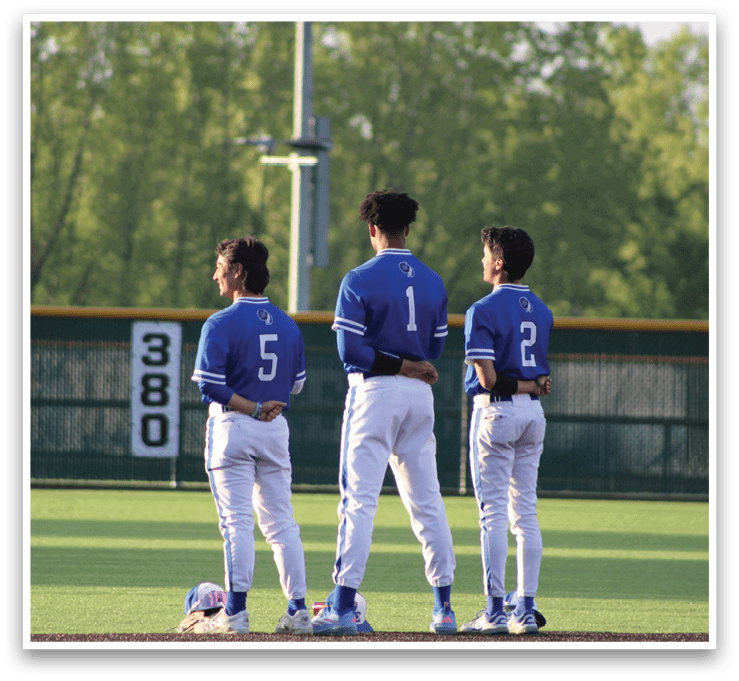 Three baseball players wearing blue and white uniforms. Description generated by AI
