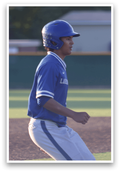 A baseball player wearing a blue and white uniform. Description generated by AI