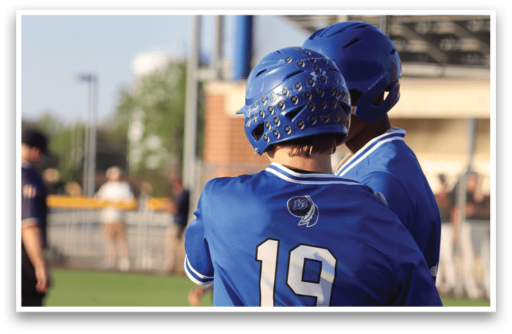 A baseball player wearing a blue shirt and blue helmet. Description generated by AI