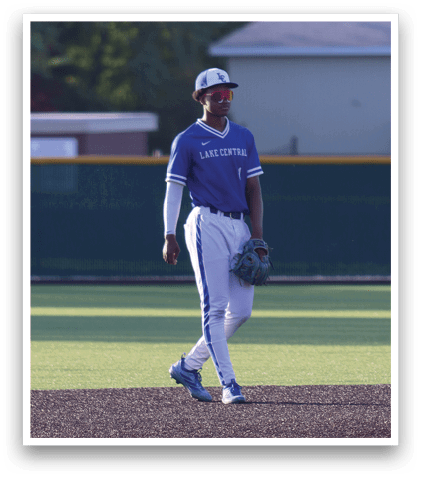 A baseball player in a blue uniform is walking on the field. Description generated by AI