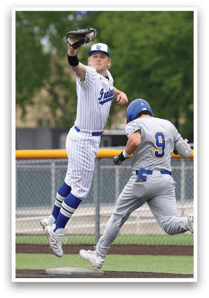 A baseball player wearing a blue helmet and white uniform is jumping in the air to catch a ball. Description generated by AI