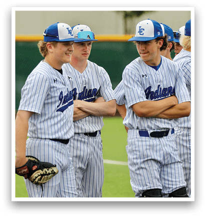 A group of baseball players wearing blue and white uniforms. Description generated by AI