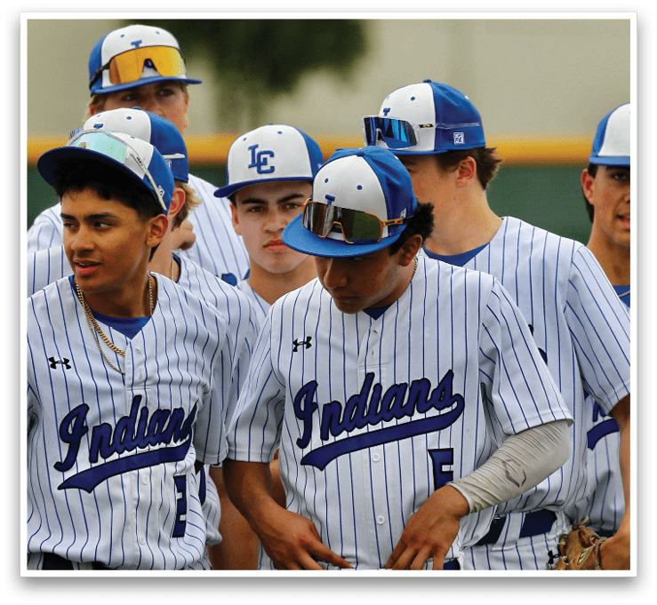 A group of baseball players wearing blue and white uniforms. Description generated by AI