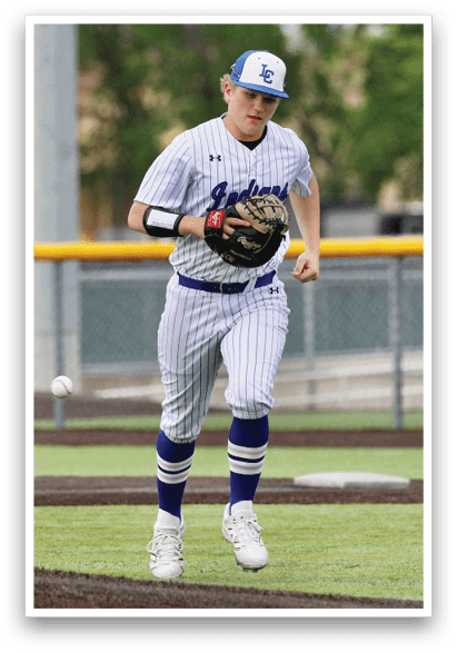 A baseball player in a white and blue uniform is running on the field. Description generated by AI