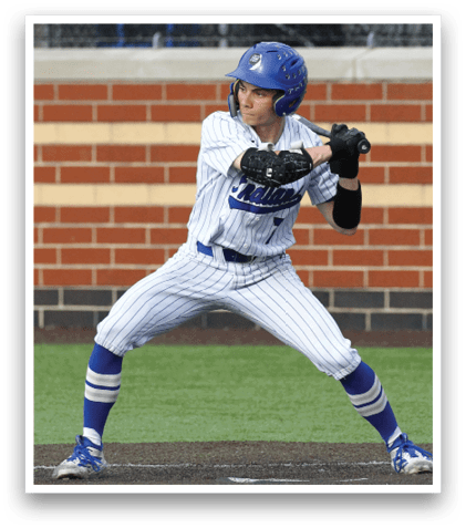 A baseball player in a blue helmet and white uniform is swinging a bat at a ball. Description generated by AI