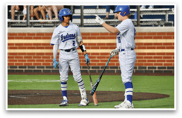 Two baseball players standing on a field. Description generated by AI