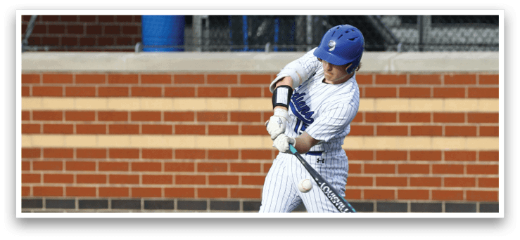 A baseball player in a white and blue uniform is swinging a bat. Description generated by AI