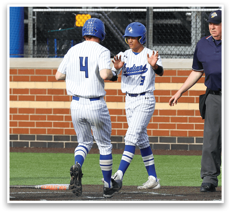 Two baseball players wearing blue and white uniforms. Description generated by AI