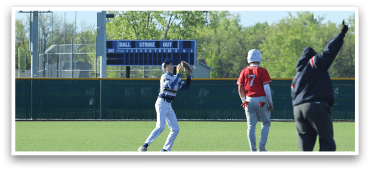 A baseball player catching a ball. Description generated by AI