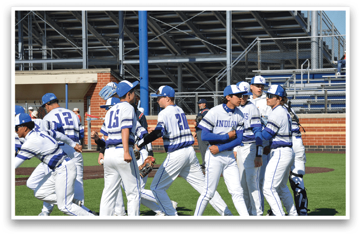 Baseball players wearing blue and white uniforms. Description generated by AI