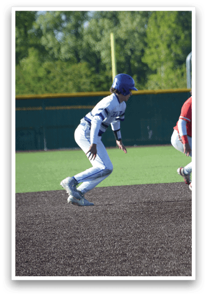 A baseball player wearing a red shirt and white pants is holding a baseball glove. Description generated by AI