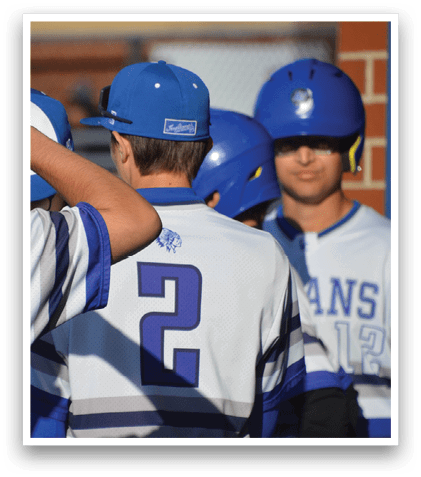 A group of baseball players wearing blue and white uniforms. Description generated by AI