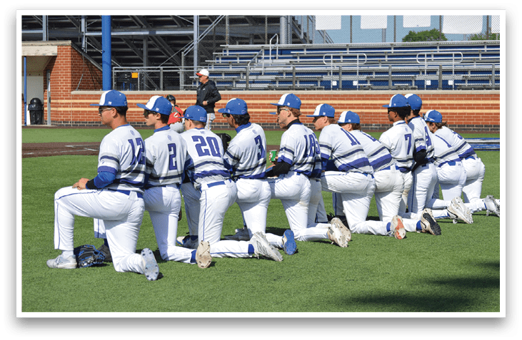 Baseball players in blue and white uniforms. Description generated by AI