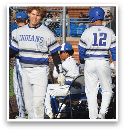 A group of baseball players wearing blue and white uniforms. Description generated by AI