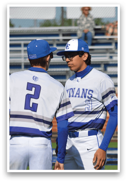 Baseball players wearing blue and white uniforms. Description generated by AI