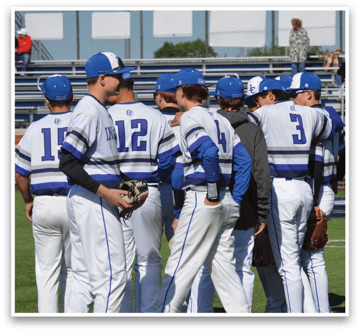 A group of baseball players wearing blue and white uniforms. Description generated by AI
