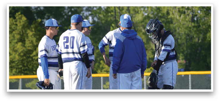 A group of baseball players standing on a field. Description generated by AI