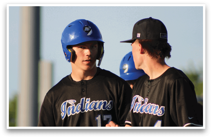 Two baseball players wearing blue helmets. Description generated by AI
