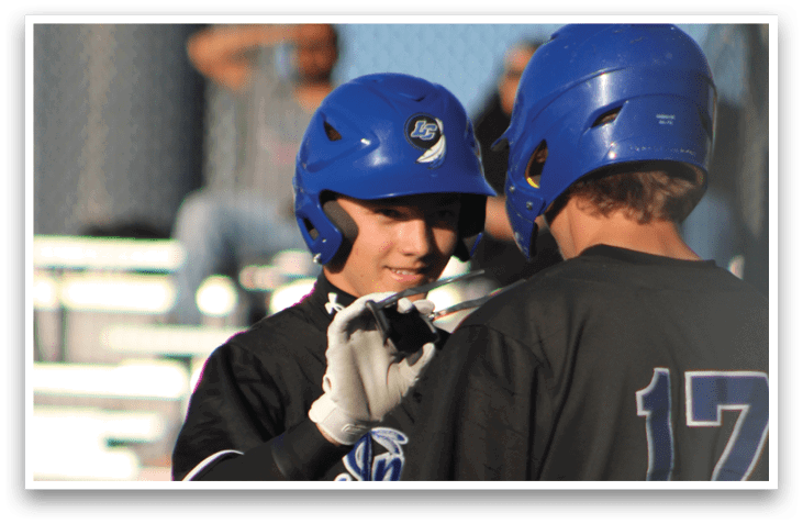 Two baseball players are hugging each other. Description generated by AI