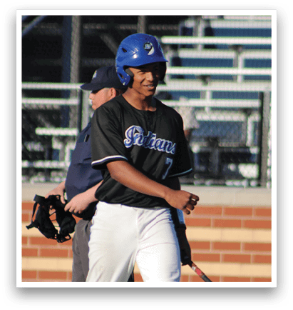 A baseball player is holding a bat and smiling. Description generated by AI