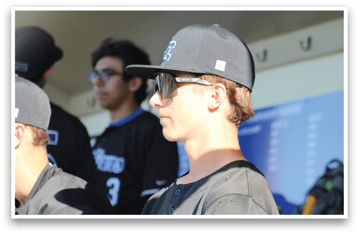 A baseball player wearing a black jersey with the number 11 on it. Description generated by AI