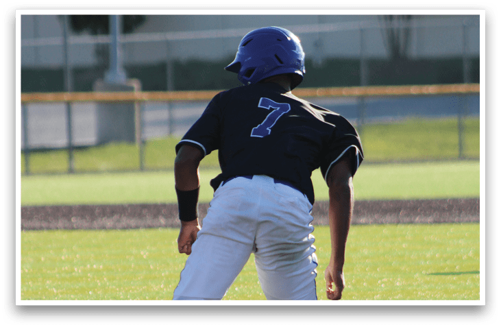 A baseball player in a black and white uniform running on the field. Description generated by AI