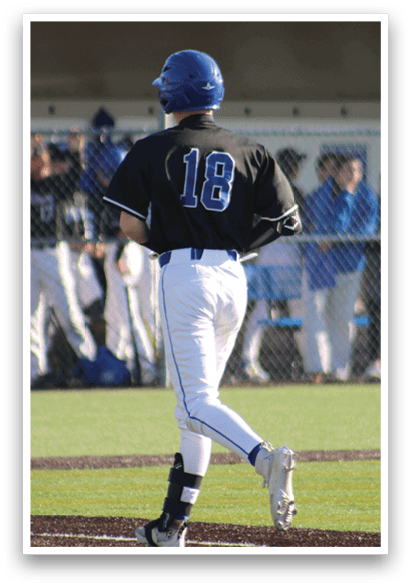 A baseball player wearing a black shirt with the number 18 on it. Description generated by AI