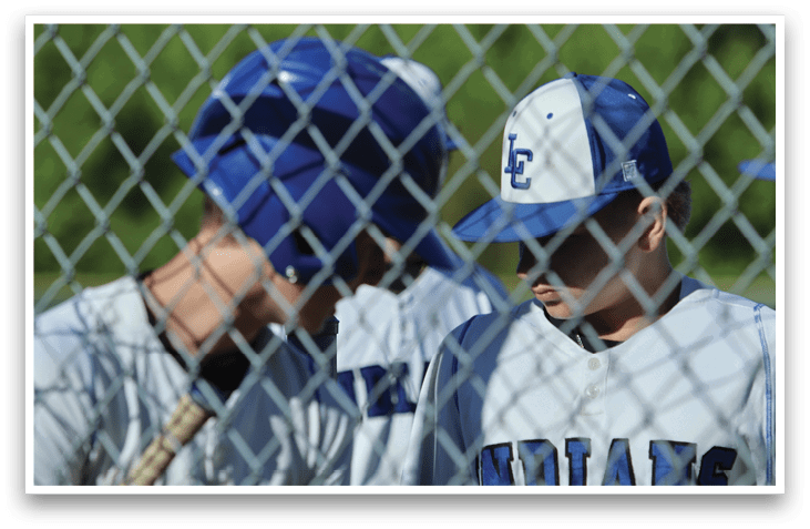 Two baseball players wearing blue and white uniforms. Description generated by AI