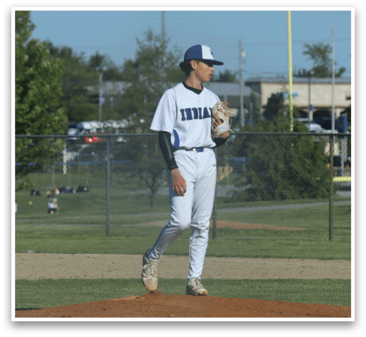 A baseball player in a white uniform with a blue number 12 on the back of it. Description generated by AI