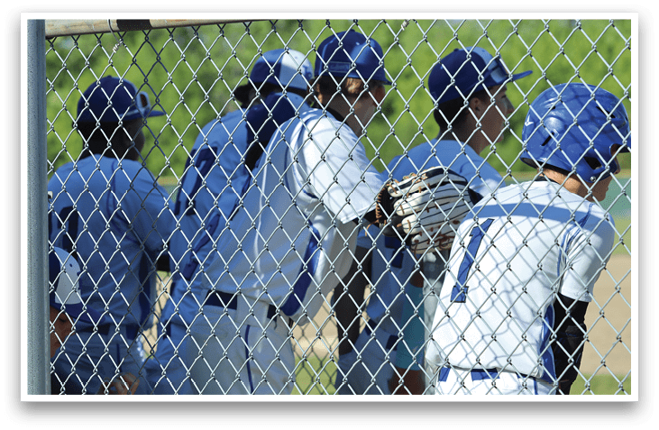 A group of baseball players wearing blue and white uniforms. Description generated by AI