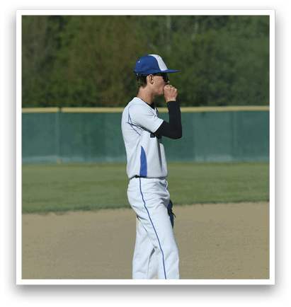 A baseball player wearing a blue and white uniform. Description generated by AI