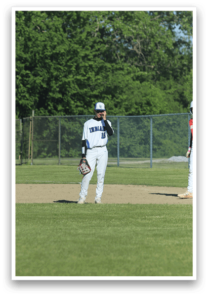 A baseball player is holding a bat and wearing a helmet. Description generated by AI