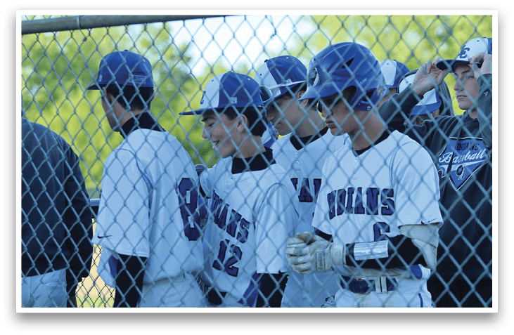 A group of baseball players wearing blue and white uniforms. Description generated by AI