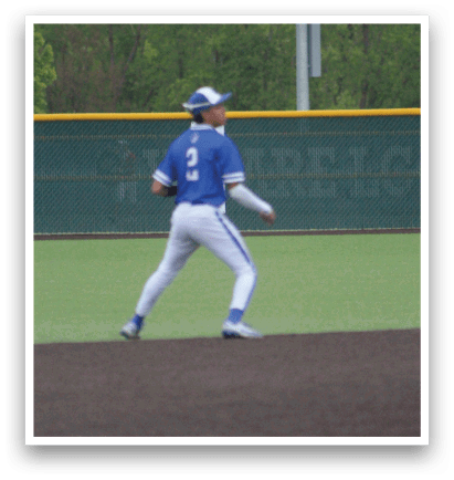 A baseball player in a blue shirt and white pants is pitching a ball. Description generated by AI
