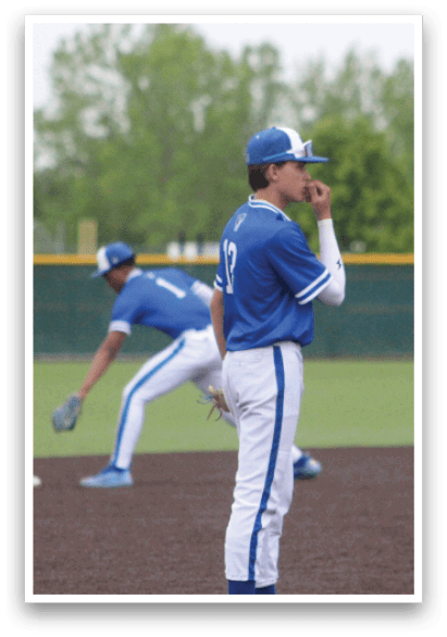 A baseball player wearing a blue and white uniform. Description generated by AI