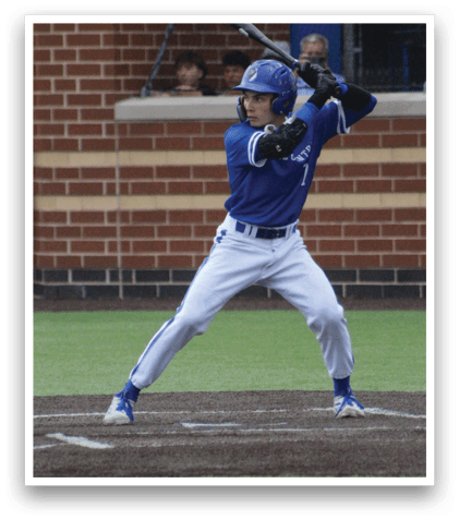 A baseball player in a blue uniform is swinging a bat. Description generated by AI