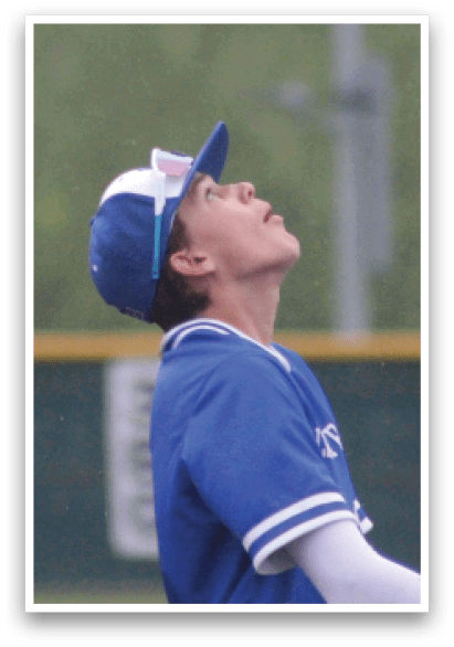 A baseball player wearing a blue and white uniform with a blue hat. Description generated by AI