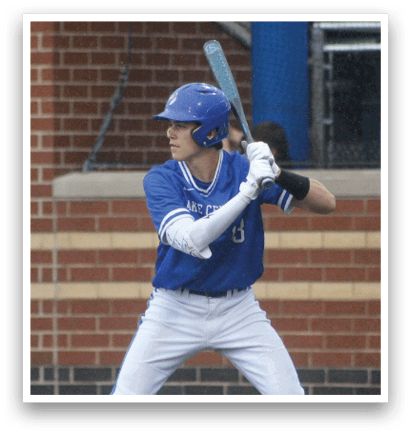 A baseball player in a blue and white uniform is holding a bat and getting ready to swing. Description generated by AI